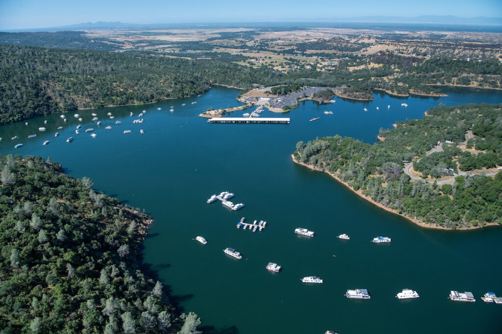 Aerial view of Lake Oroville in Butte County with a string of boats on the lake